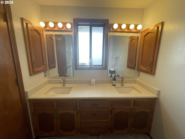 full bathroom with double vanity and a sink