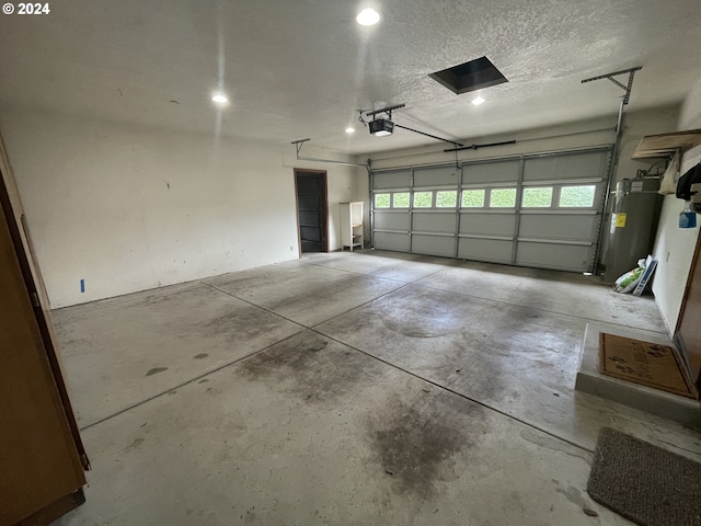 garage with electric water heater and a garage door opener