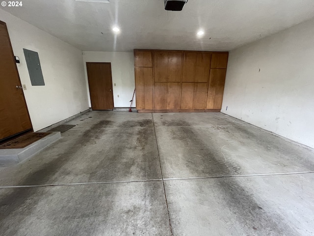 parking garage with electric panel and a garage door opener