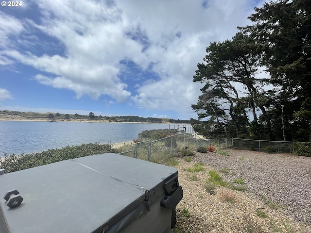 view of yard featuring a water view and fence