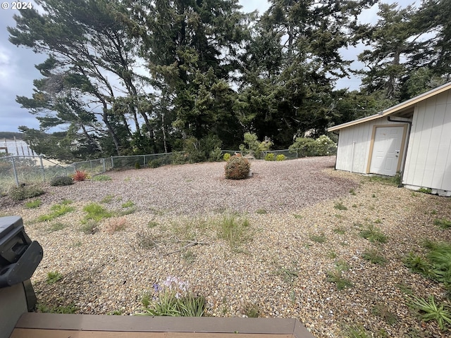 view of yard with an outbuilding and a fenced backyard