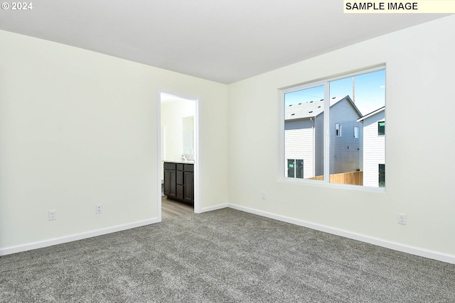 spare room with light carpet and sink