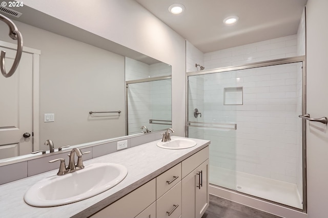 bathroom with vanity, hardwood / wood-style flooring, and walk in shower