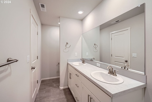 bathroom with vanity and hardwood / wood-style flooring