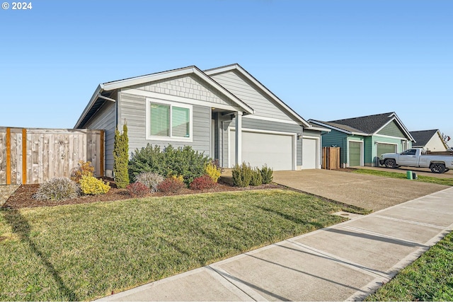 view of front facade featuring a garage and a front lawn