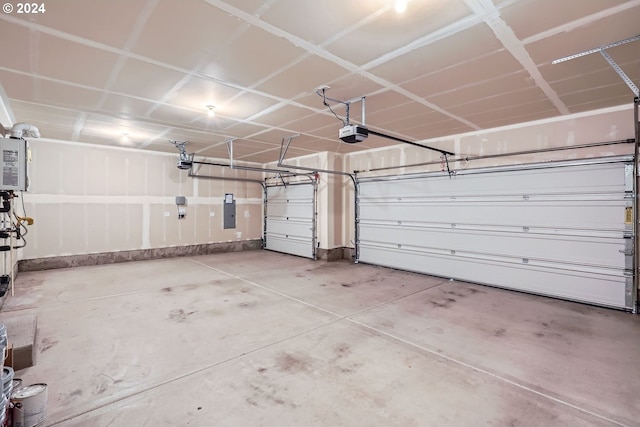 garage with electric panel and a garage door opener