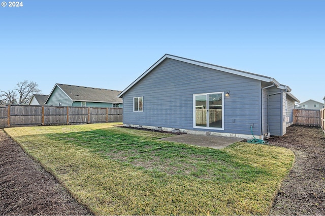 back of property with a patio and a lawn