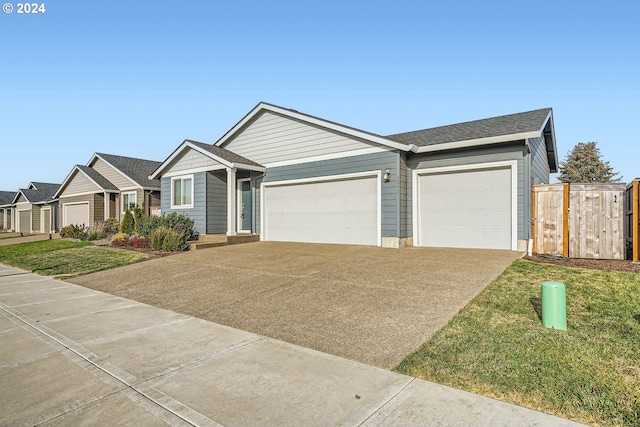 ranch-style home featuring a front lawn and a garage