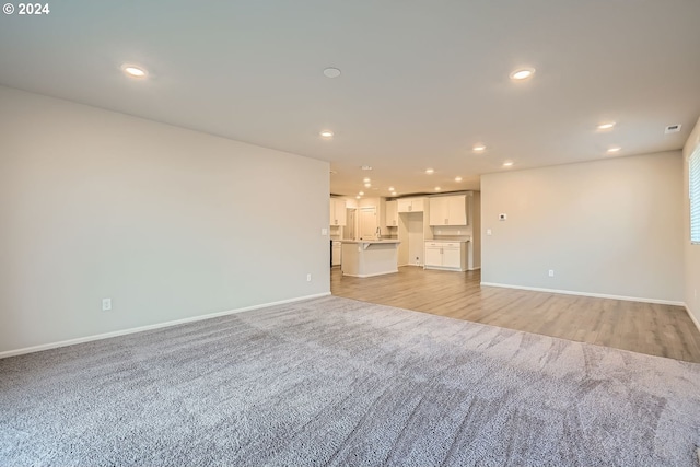 unfurnished living room featuring light hardwood / wood-style flooring