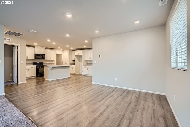 unfurnished living room with light hardwood / wood-style floors