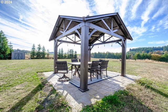 view of patio featuring a gazebo and a storage shed