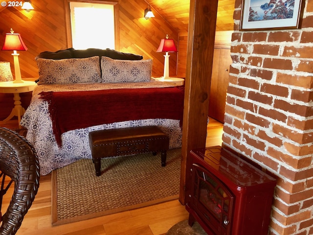 bedroom featuring light hardwood / wood-style floors and wood walls