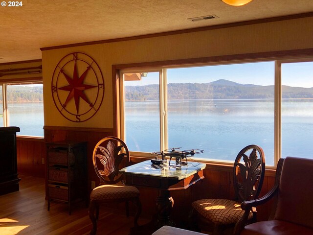 bar featuring hardwood / wood-style floors and a water and mountain view