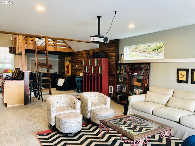 living room with wood-type flooring, wooden walls, and vaulted ceiling