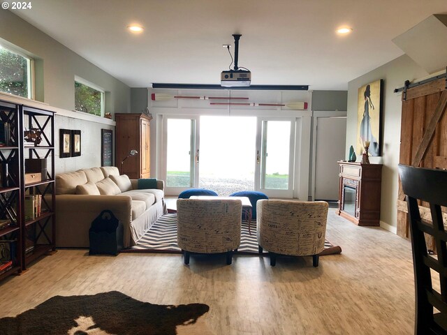 living room with wood-type flooring, wooden walls, and vaulted ceiling