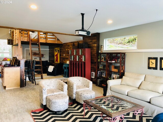 living room featuring hardwood / wood-style flooring, lofted ceiling, and wood walls