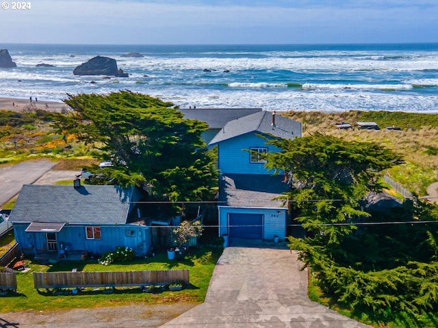 drone / aerial view featuring a water view and a view of the beach