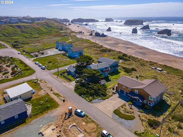 aerial view with a water view and a view of the beach