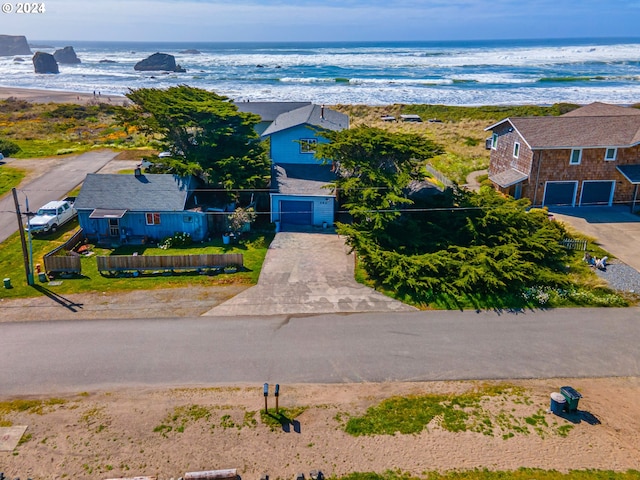 drone / aerial view featuring a water view and a beach view