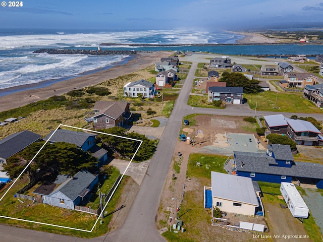 drone / aerial view featuring a view of the beach and a water view