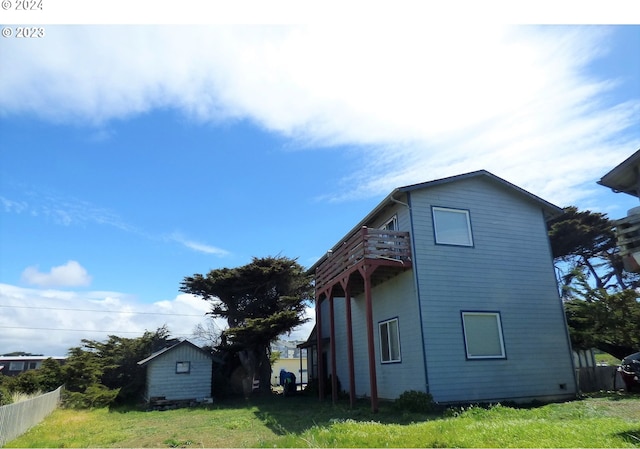 view of property exterior featuring a storage shed and a yard