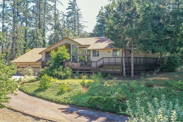 view of front of property with concrete driveway, roof with shingles, and an attached garage