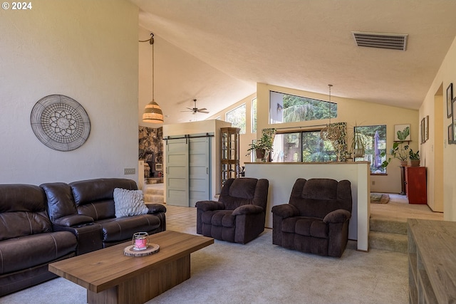 living room featuring light carpet, a barn door, lofted ceiling, and visible vents