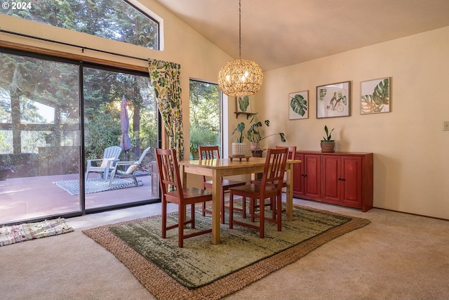 dining space with a chandelier, light carpet, and high vaulted ceiling