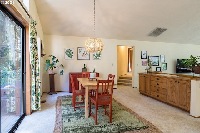 dining room with light carpet, visible vents, an inviting chandelier, and stairs