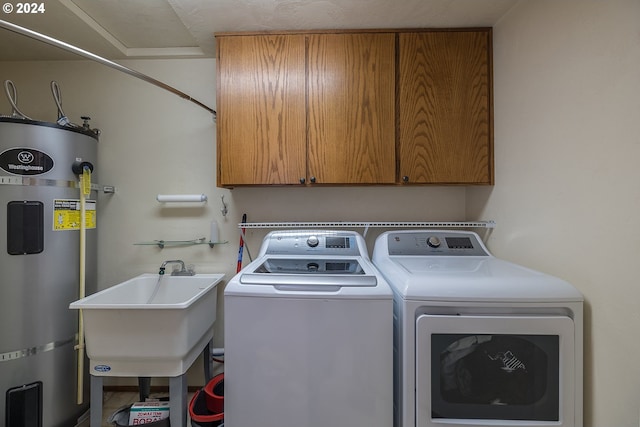 laundry area with cabinet space, secured water heater, a sink, and independent washer and dryer