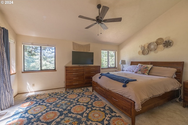 bedroom featuring light colored carpet, vaulted ceiling, and ceiling fan