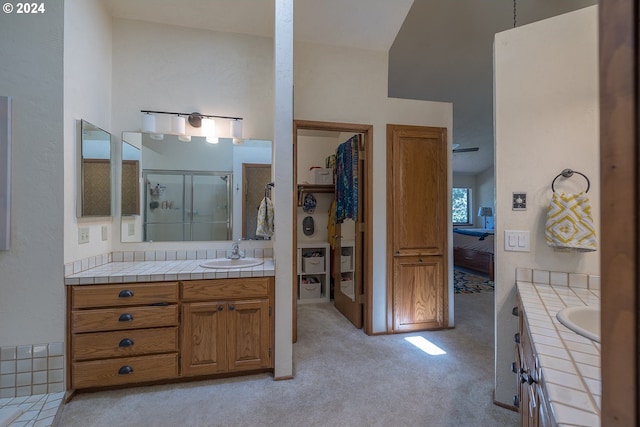 bathroom with ensuite bathroom, a stall shower, and vanity