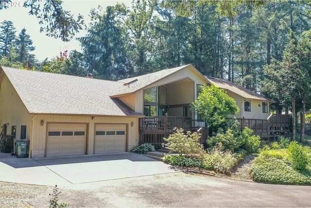 view of front facade featuring driveway, a garage, stairway, and roof with shingles