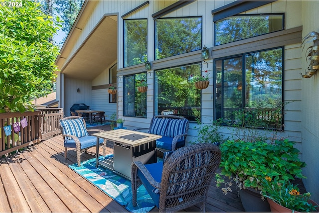 wooden deck with an outdoor living space