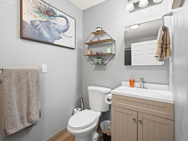 bathroom featuring vanity, wood-type flooring, and toilet