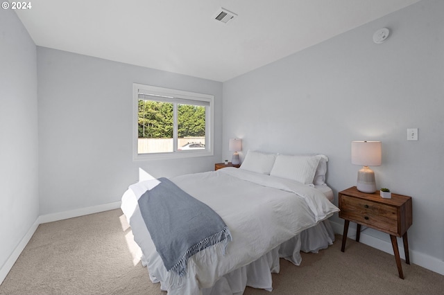 bedroom with light colored carpet