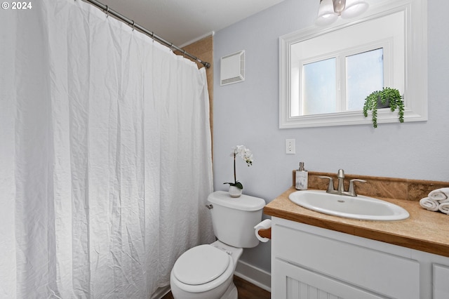 bathroom with vanity, toilet, and a shower with shower curtain