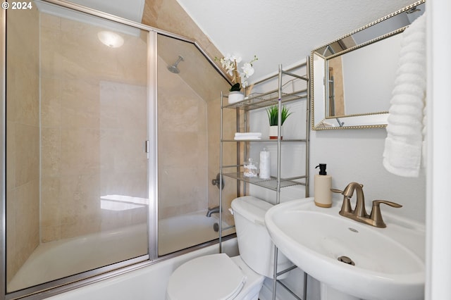 full bathroom featuring sink, enclosed tub / shower combo, and toilet