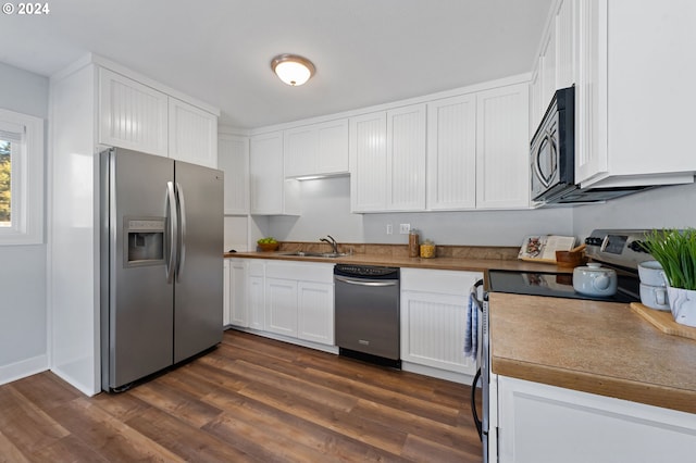 kitchen with stainless steel appliances, white cabinetry, dark hardwood / wood-style floors, and sink