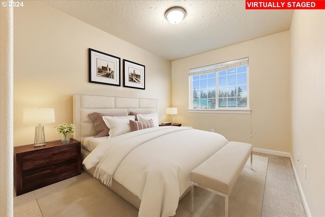 carpeted bedroom with a textured ceiling