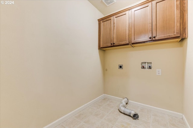 laundry room featuring gas dryer hookup, cabinets, hookup for a washing machine, light tile patterned floors, and hookup for an electric dryer