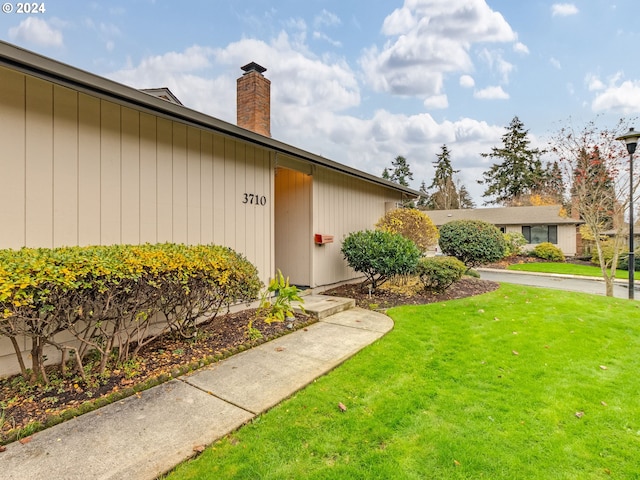 property entrance with a yard