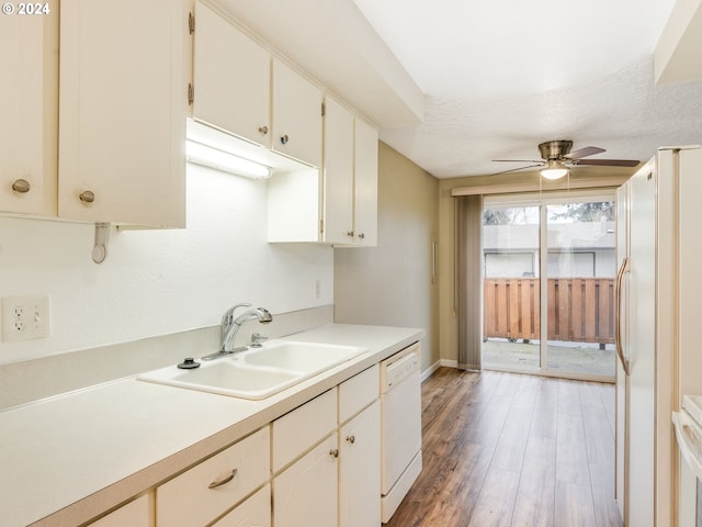 kitchen with a textured ceiling, white appliances, ceiling fan, sink, and light hardwood / wood-style flooring