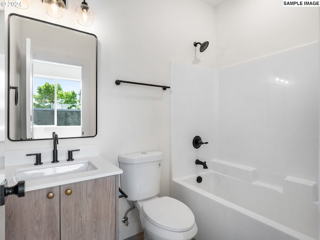 full bathroom featuring vanity, bathtub / shower combination, and toilet