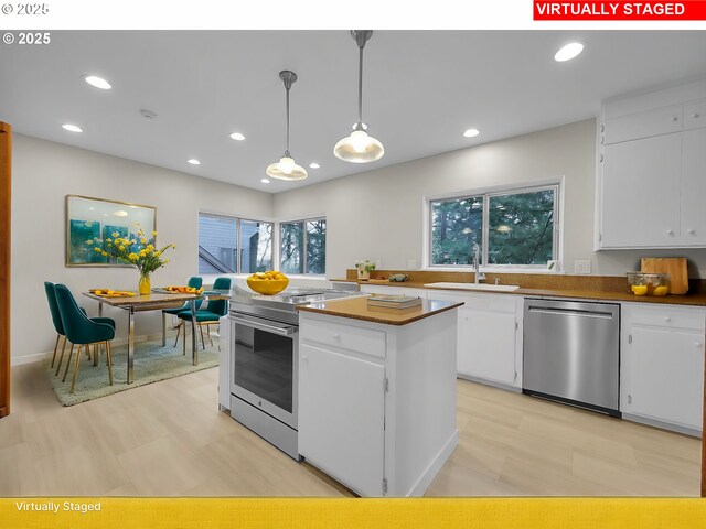 kitchen featuring sink, white cabinets, and dishwasher