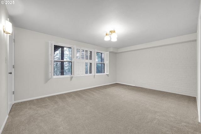 unfurnished room with brick wall and carpet flooring