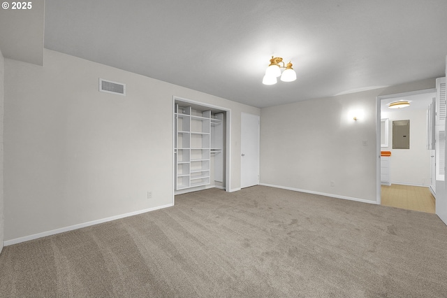 carpeted empty room featuring electric panel