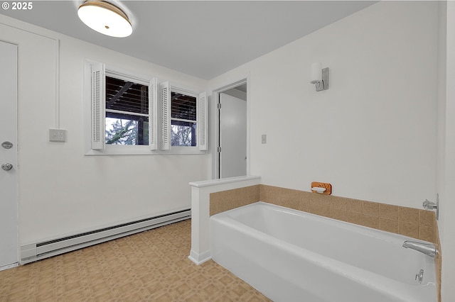 bathroom with a baseboard heating unit and a tub to relax in