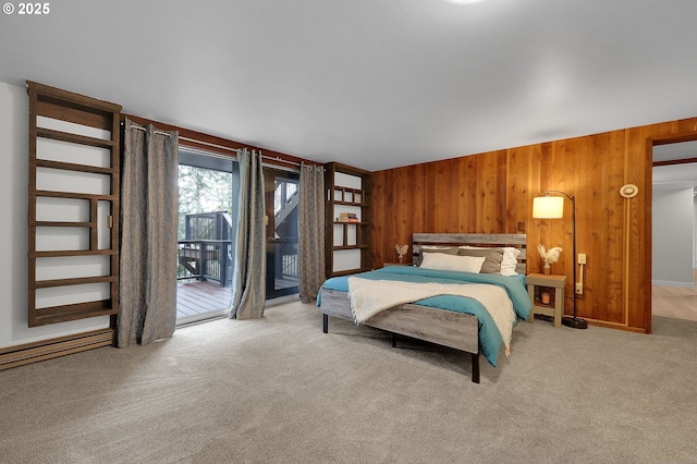 carpeted bedroom with wood walls and access to exterior