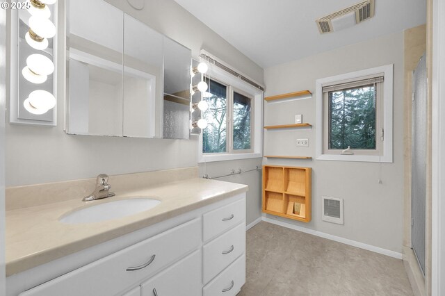 bathroom with toilet and stacked washer / dryer